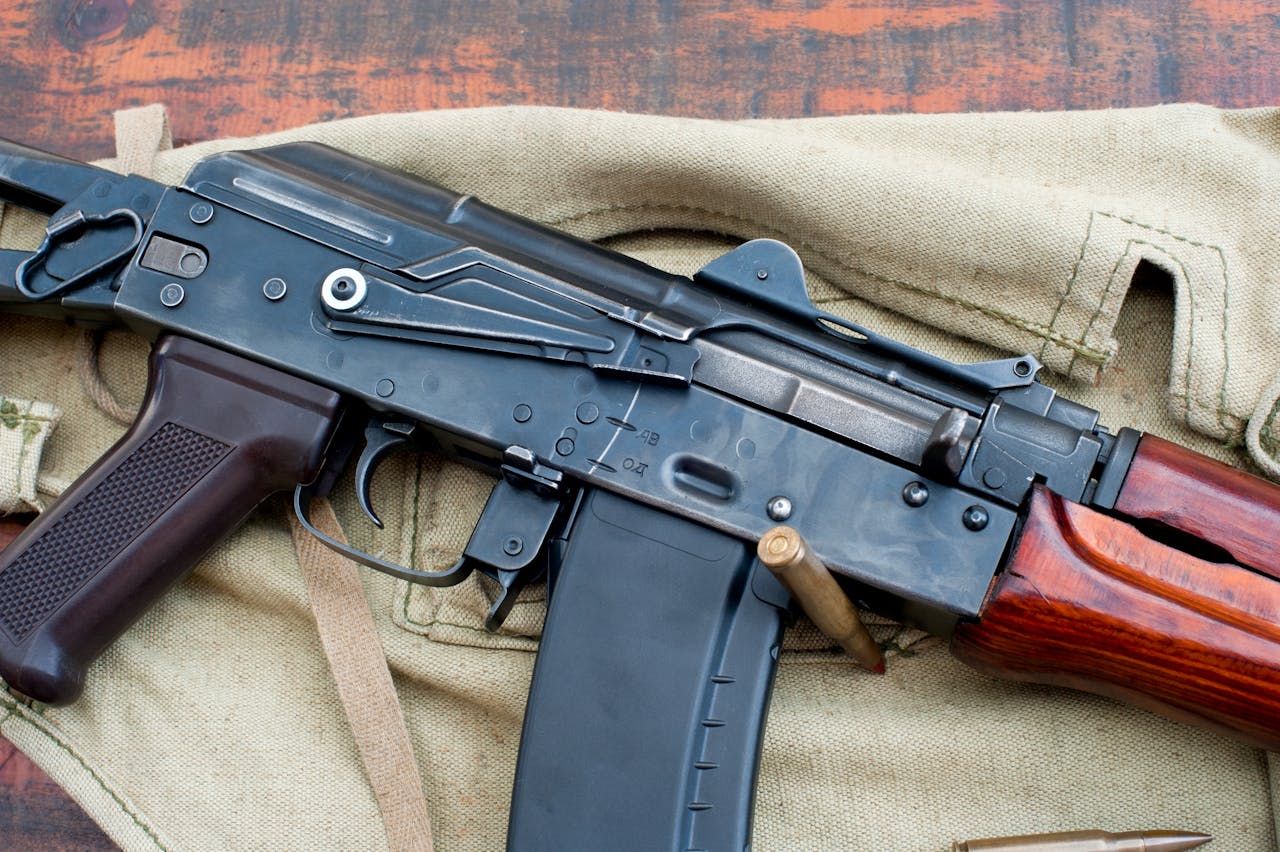 The Art of Drawing Readers In: Your attractive post title goes here A detailed view of a military rifle with ammunition on a canvas backdrop.